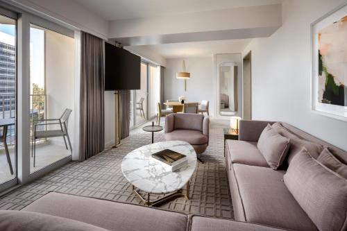 a living room with a couch and a table at Fairmont Century Plaza Los Angeles at Beverly Hills in Los Angeles