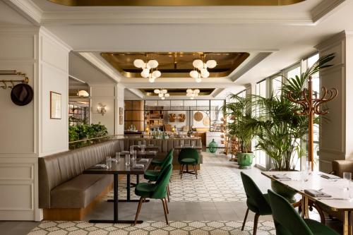 a restaurant with green chairs and tables at Fairmont Century Plaza Los Angeles at Beverly Hills in Los Angeles