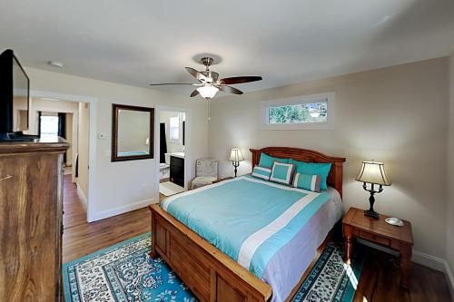 a bedroom with a bed and a ceiling fan at Cool Springs Manor in Asheville
