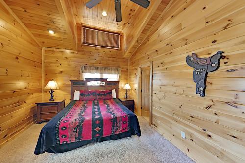 a bedroom with a bed in a log cabin at Gatlinburg Falls Cabin Unit 812 in Gatlinburg