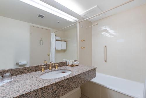 a bathroom with a sink and a shower at Hotel Grand Chancellor Launceston in Launceston