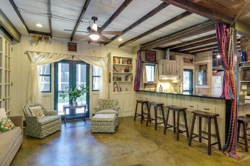 a living room with a bar and some chairs at Little House Nashville - Guest House in Nashville