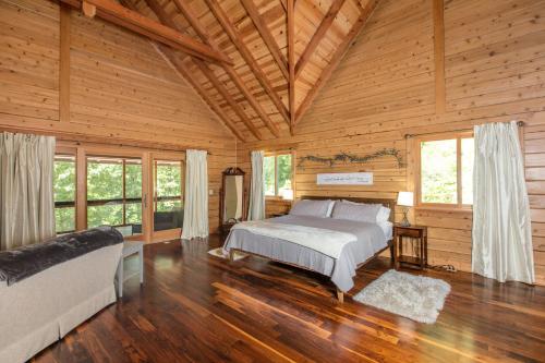 a bedroom with a bed in a wooden cabin at Hidden Cove in Lake Lure