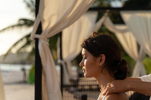 a woman standing in front of a tent at The Beach Samui in Taling Ngam Beach