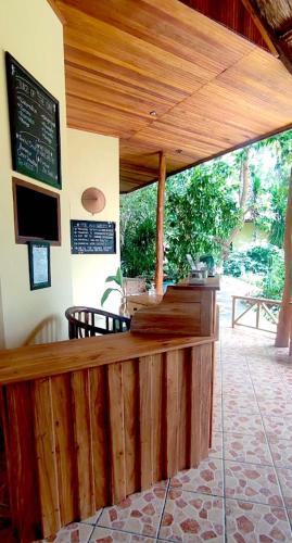 a bar in a restaurant with a wooden counter at Bara Beach Bungalows in Bira