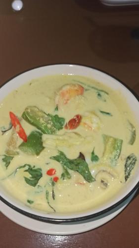a bowl of soup with vegetables on a table at Tao Thong Villa 2 in Ko Tao