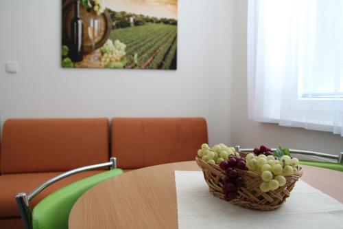 a basket of grapes sitting on a table at Penzion Bobule in Staré Město