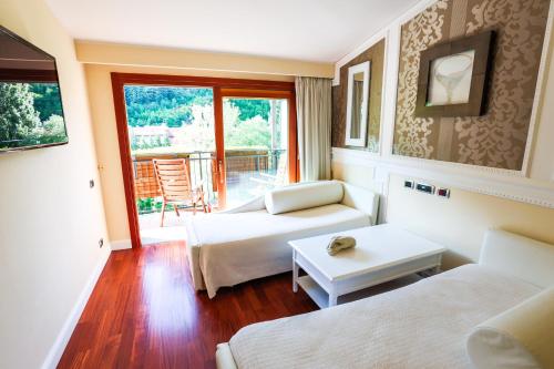 a living room with two beds and a table at Euroterme in Bagno di Romagna