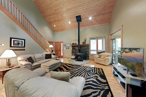 a living room with two couches and a tv at Rhymer Haven in Juno