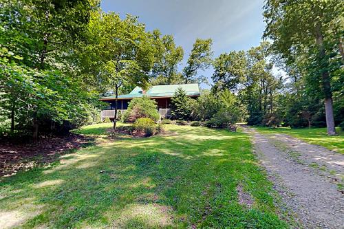a house with a gravel road in front of it at Rhymer Haven in Juno