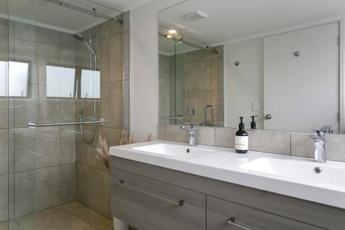 a bathroom with a sink and a shower at Acacia Bay in Taupo