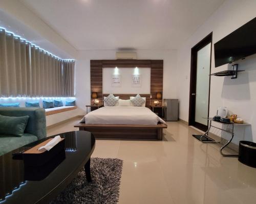 a large bedroom with a bed and a couch at B'da2ri Butiq Villa in Seminyak
