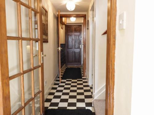 a hallway with a black and white checkered floor at The Antlers in Coldstream