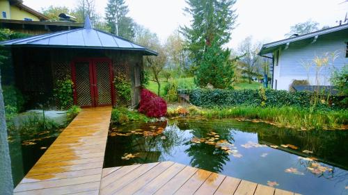 a garden with a pond and a gazebo at Kaiserhaus Harald Astner Ebbs Studio 2 in Ebbs
