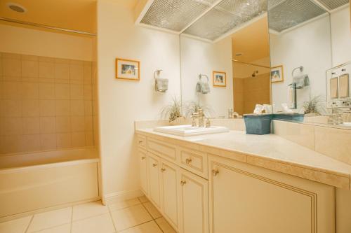 a bathroom with a sink and a mirror at Villas of Kamali'i 56 condo in Princeville