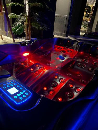 a remote control sitting on top of a video game table at La suite Grenoble spa jacuzzi et sauna privatif in Grenoble