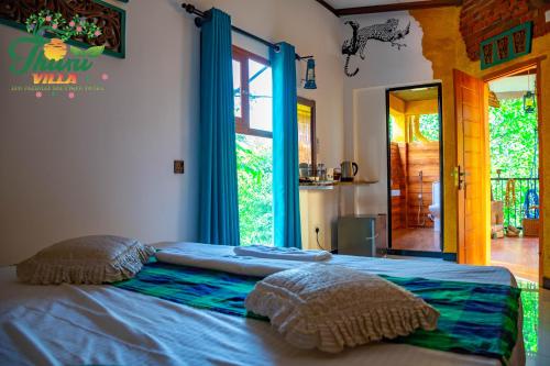 a bedroom with a bed with two pillows on it at THURU VILLA in Katunayaka