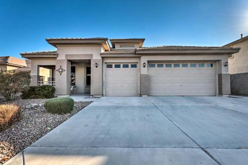 a house with two garage doors and a driveway at Heated Pool, Gas Grill and Yard Phoenix Retreat! in Avondale