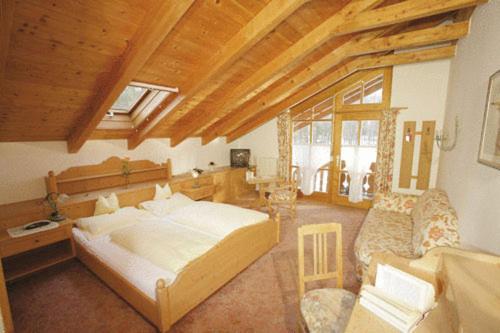a bedroom with a bed and a living room at Eichenhof in Waging am See
