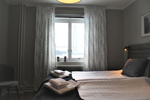 a bedroom with a bed with two towels on it at Sjövillan Bed & Breakfast in Sandöverken