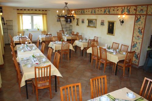 ein Esszimmer mit Tischen und Stühlen in einem Restaurant in der Unterkunft Hotel zum Ritter Nidderau in Nidderau