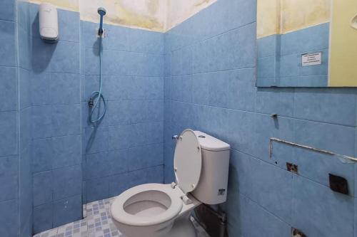a bathroom with a toilet and a shower at Good Sleep Balikpapan Mitra RedDoorz in Balikpapan