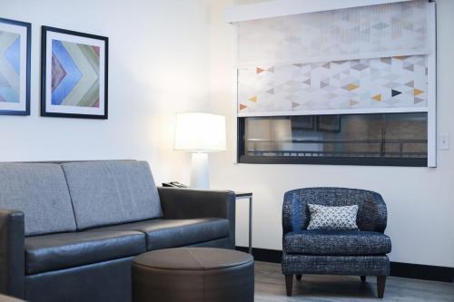 a living room with a couch and a chair at Holiday Inn & Suites St. Cloud by IHG in Saint Cloud