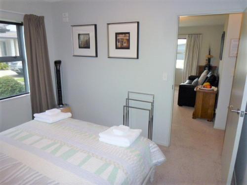 a bedroom with a bed with two towels on it at Aquila Haven in Whitianga