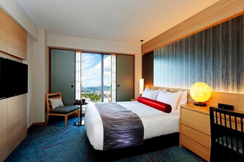 een hotelkamer met een bed en een groot raam bij RIHGA Royal Hotel Kyoto in Kyoto