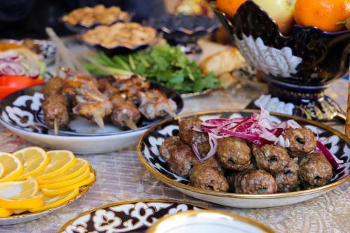 a table with plates of food on a table at Hotel Jasmina in Samarkand