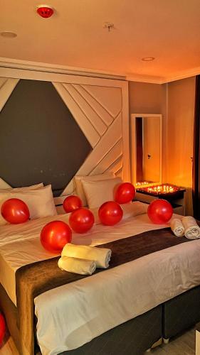 a bed with red balloons on top of it at Heaven Suite Hotel in Trabzon