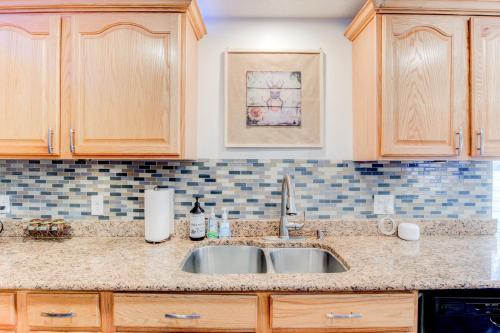a kitchen counter with a sink and wooden cabinets at Modern Private Whole Unit 4 Bedroom Guest Suite King Bed in Salt Lake City