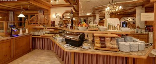 a kitchen with a counter with dishes on it at Hotel Unser Unterberg in Maria Alm am Steinernen Meer