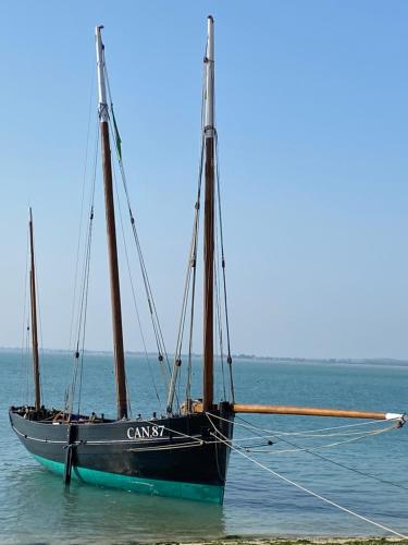 a boat sitting on the water in the ocean at STUDIO CANCALE - PORT DE LA HOULE - classé 2 étoiles in Cancale