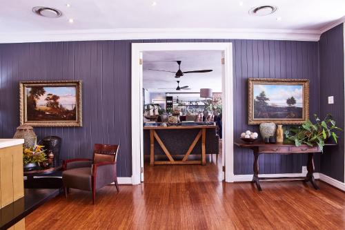 a living room with a bar with purple walls at The Devon Valley Hotel in Stellenbosch