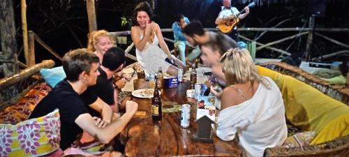 a group of people sitting around a table at Stilts Diani Beach in Diani Beach