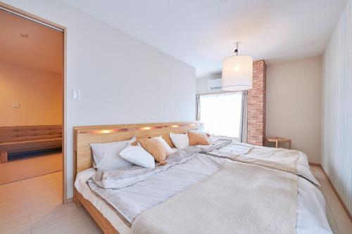 Postel nebo postele na pokoji v ubytování 王子神谷ハウス OJIKAMIYA HOUSE