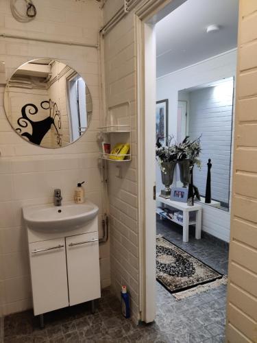a bathroom with a sink and a mirror at Apartment Nonna in Keuruu