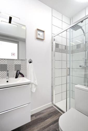 a white bathroom with a shower and a toilet at Hypercentre 9 rue de la ROE in Angers