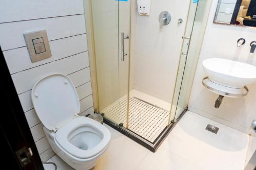 a bathroom with a toilet and a sink at Hotel Grand Godwin - Free Airport Pick-Up in New Delhi