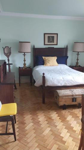 a bedroom with a bed and two tables and two lamps at Casa de São João in Viana do Castelo