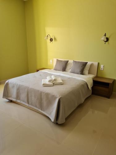a bedroom with a bed with two towels on it at Grundenberga hotel with self check-in in Baldone