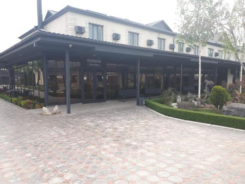 a building with a lot of windows and a courtyard at комплекс гостиниц Athletic in Taraz