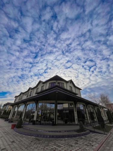 a large building with a sky in the background at комплекс гостиниц Athletic in Taraz