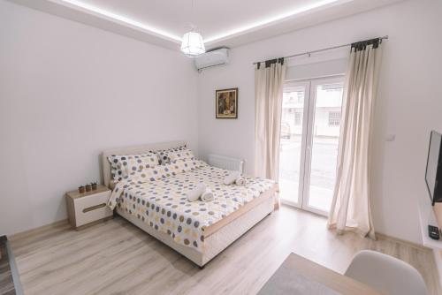 a bedroom with a bed and a large window at VS Studio Apartmani Banja Koviljača in Banja Koviljača