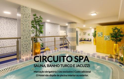 a spa room with a swimming pool in a building at Aurea Fatima Hotel Congress & Spa in Fátima