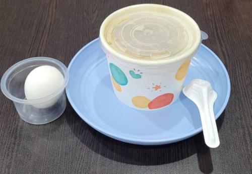 a cup of coffee on a plate with a spoon at 花蓮亮君經典民宿1館加2館民宿-東大門夜市-電梯包棟Bright King Homestay in Hualien City