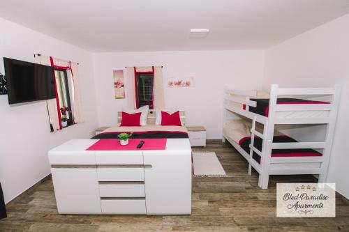 a bedroom with a bed and a bunk bed at Bled Paradise Apartments in Bled