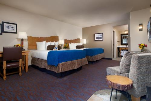 a hotel room with two beds and a couch at The Rockwell Inn in Jackson