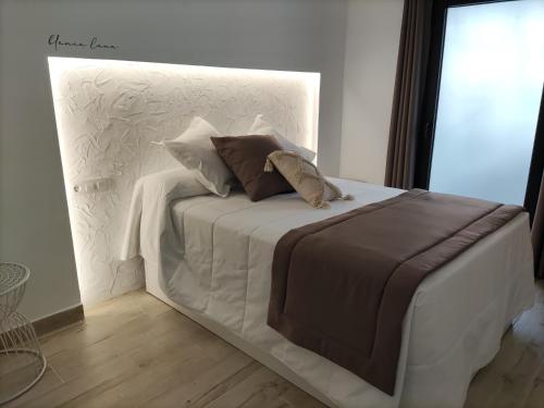 a white bed with two pillows on top of it at PIEDRA DE LUNA in Merida